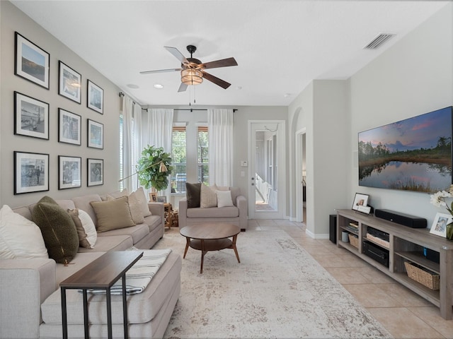 tiled living room with ceiling fan