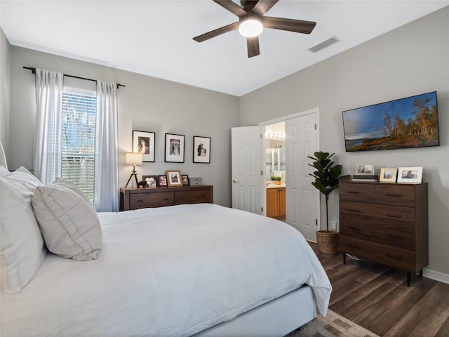 bedroom featuring ensuite bath, dark hardwood / wood-style floors, and ceiling fan