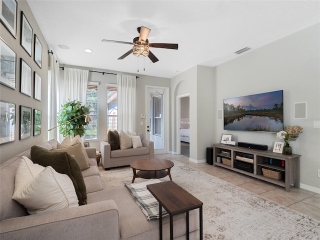 tiled living room with ceiling fan