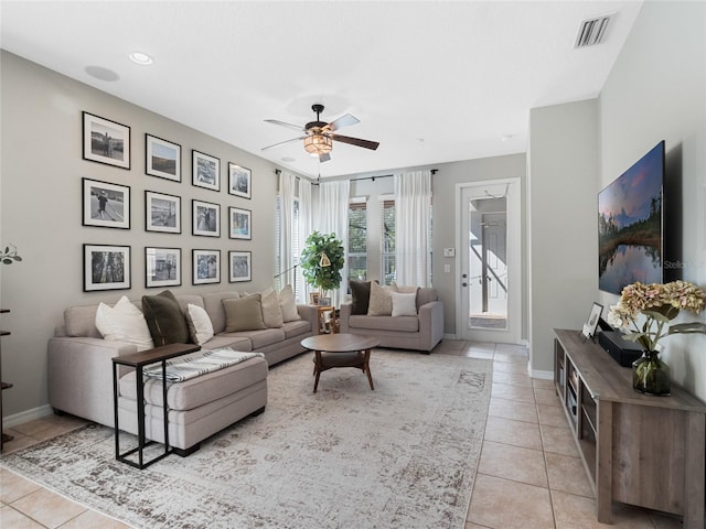 living room featuring light tile patterned floors and ceiling fan