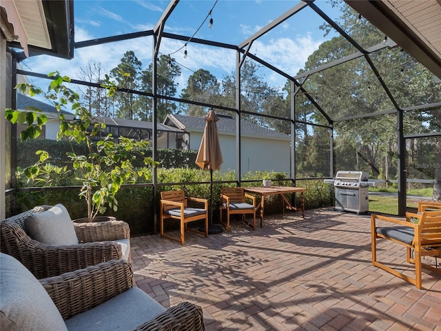 view of patio / terrace featuring area for grilling and glass enclosure