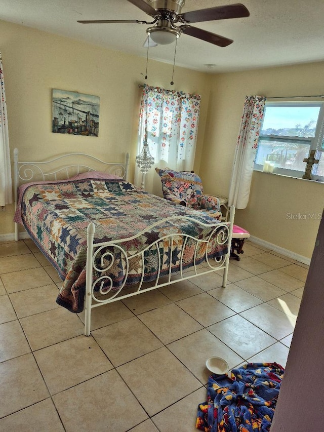 bedroom with tile patterned floors and ceiling fan