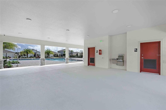 unfurnished living room featuring a textured ceiling