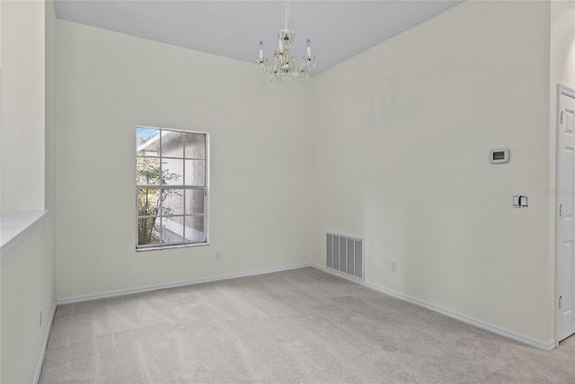 unfurnished room with light colored carpet and an inviting chandelier