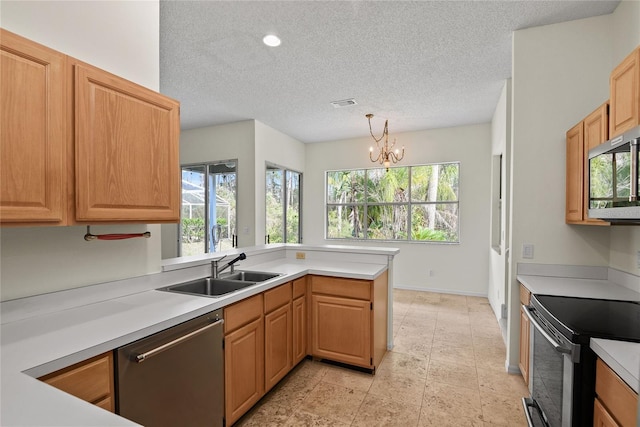 kitchen with sink, an inviting chandelier, decorative light fixtures, appliances with stainless steel finishes, and kitchen peninsula