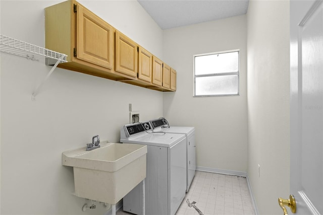 laundry room with cabinets, separate washer and dryer, and sink