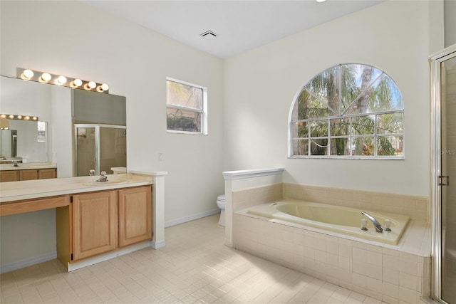 full bathroom featuring vanity, tile patterned floors, shower with separate bathtub, and toilet