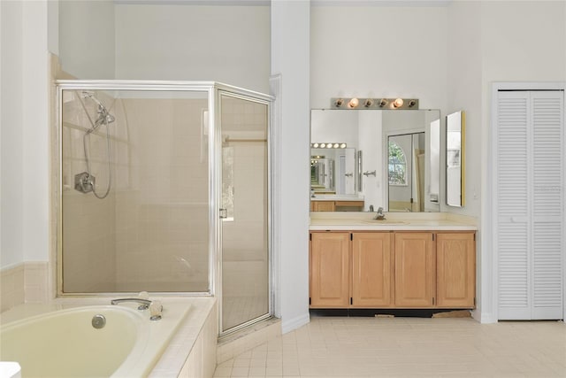 bathroom with vanity, shower with separate bathtub, and tile patterned flooring