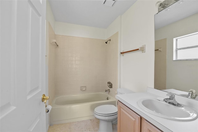 full bathroom featuring vanity, tiled shower / bath combo, and toilet