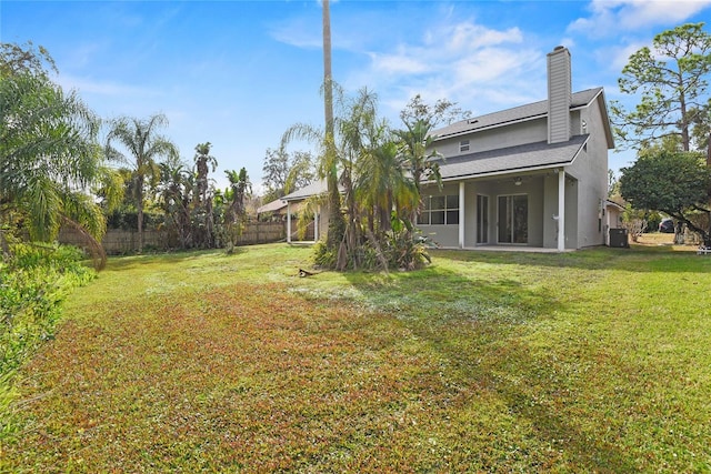 back of house with a lawn