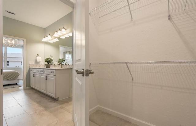 bathroom with tile patterned floors and vanity