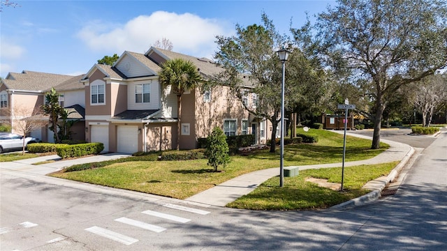 view of front facade featuring a garage and a front yard