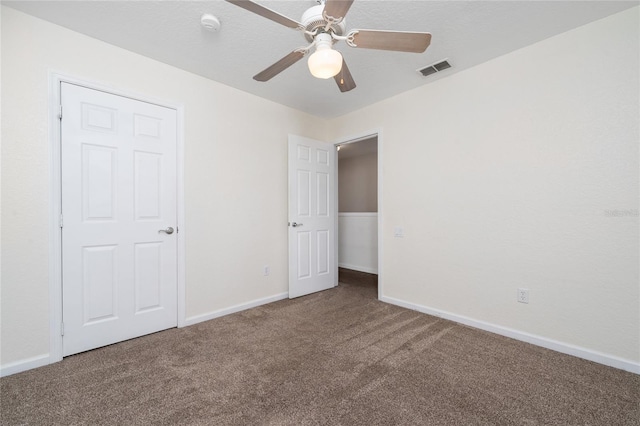 unfurnished bedroom with carpet flooring, a textured ceiling, and ceiling fan