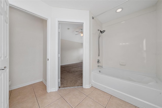 bathroom featuring tile patterned flooring and bathing tub / shower combination