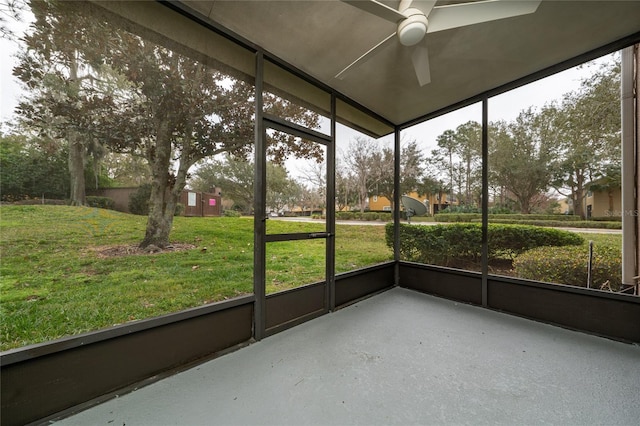 unfurnished sunroom featuring ceiling fan and a healthy amount of sunlight