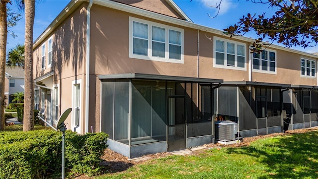 rear view of property with a yard and central AC unit