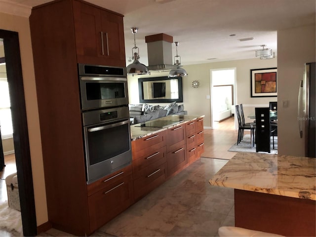 kitchen with pendant lighting, black electric stovetop, stainless steel fridge, and butcher block counters