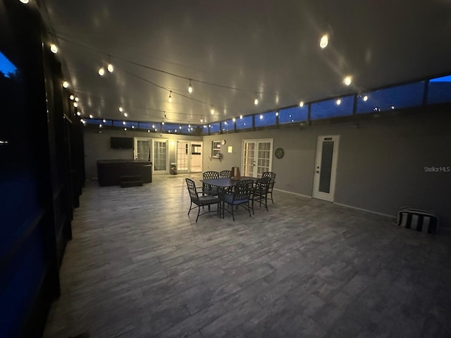 patio at twilight featuring a hot tub