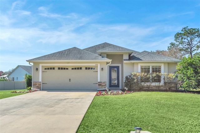 view of front of property featuring a garage and a front lawn