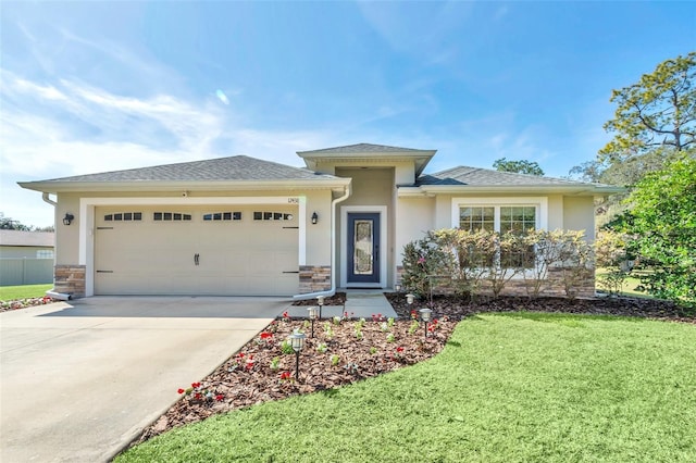 prairie-style home featuring a garage and a front yard