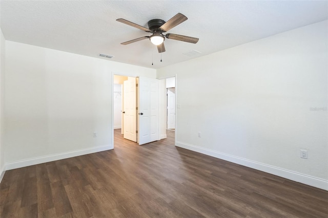 empty room featuring dark hardwood / wood-style floors, a textured ceiling, and ceiling fan