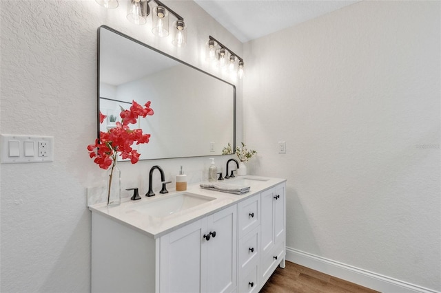 bathroom with vanity and hardwood / wood-style floors