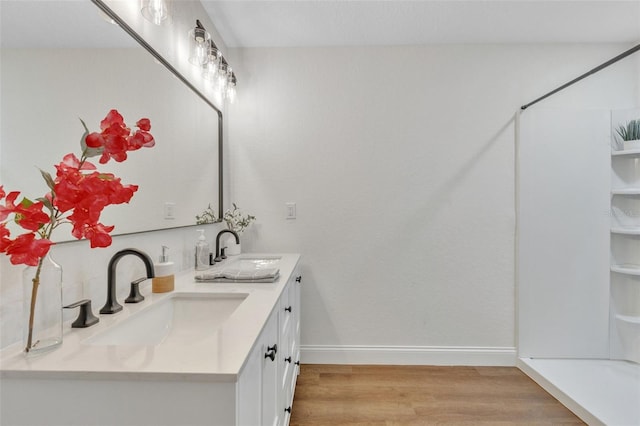 bathroom with wood-type flooring and vanity