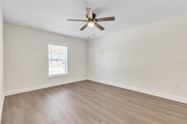 unfurnished room featuring a textured ceiling, wood-type flooring, and ceiling fan