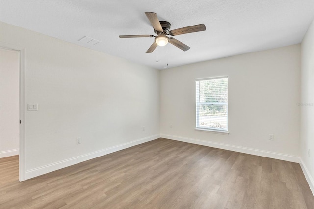 spare room with ceiling fan and light hardwood / wood-style floors