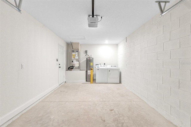 garage featuring washing machine and clothes dryer, a garage door opener, electric water heater, and heating unit