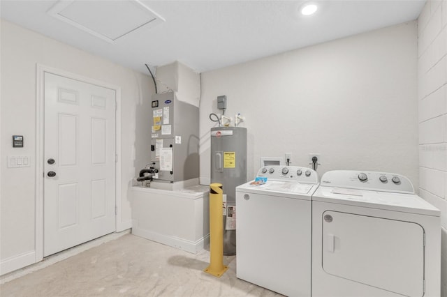 laundry area featuring electric water heater, washer and dryer, and heating unit