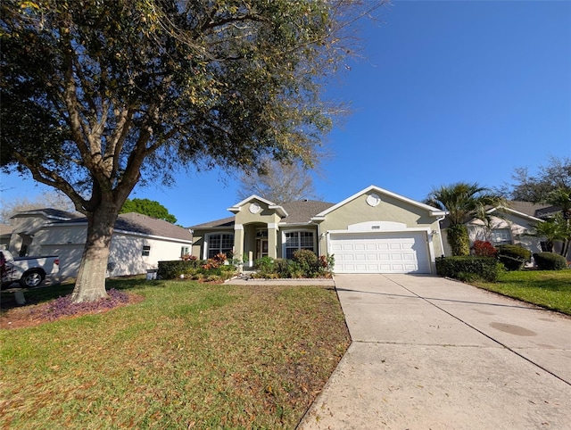 view of front of property featuring an attached garage, driveway, a front lawn, and stucco siding