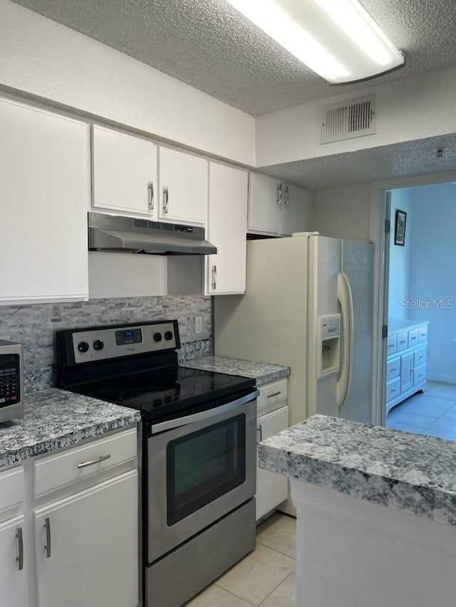 kitchen featuring white cabinetry, light tile patterned floors, electric range, and backsplash