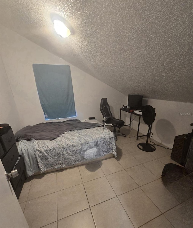 tiled bedroom with lofted ceiling and a textured ceiling