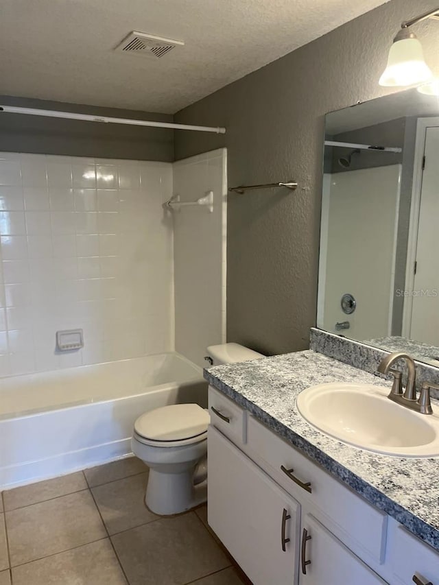 full bathroom with shower / bath combination, vanity, toilet, tile patterned floors, and a textured ceiling