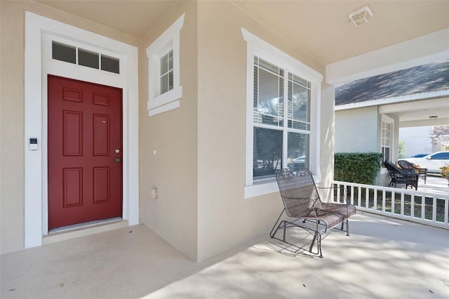 doorway to property with covered porch