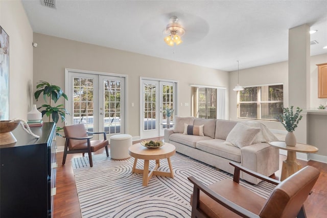 living room with wood-type flooring, french doors, and ceiling fan