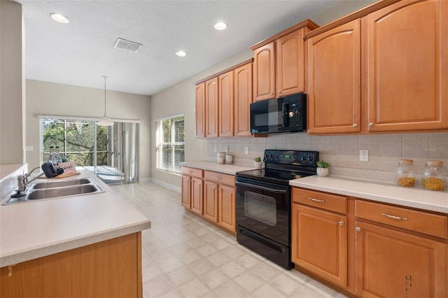 kitchen featuring tasteful backsplash, sink, hanging light fixtures, and black appliances