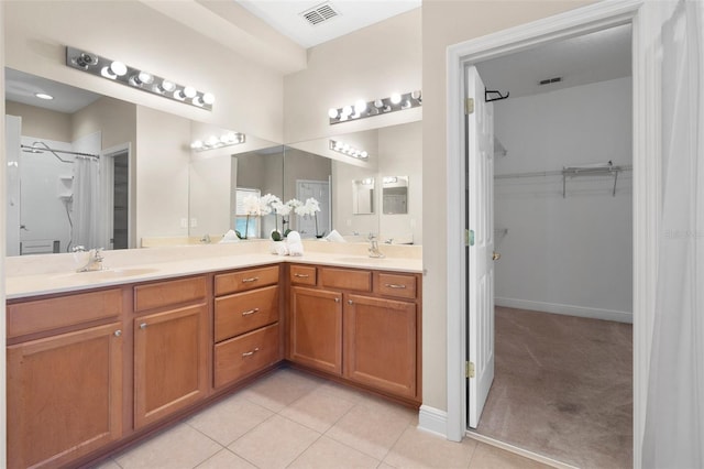 bathroom featuring vanity, tile patterned floors, and walk in shower