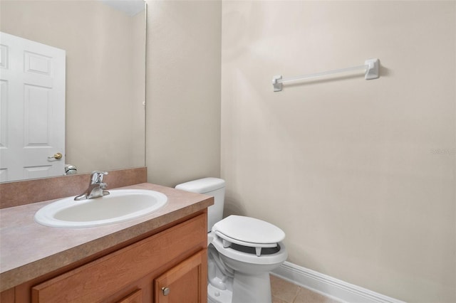 bathroom featuring vanity, tile patterned floors, and toilet