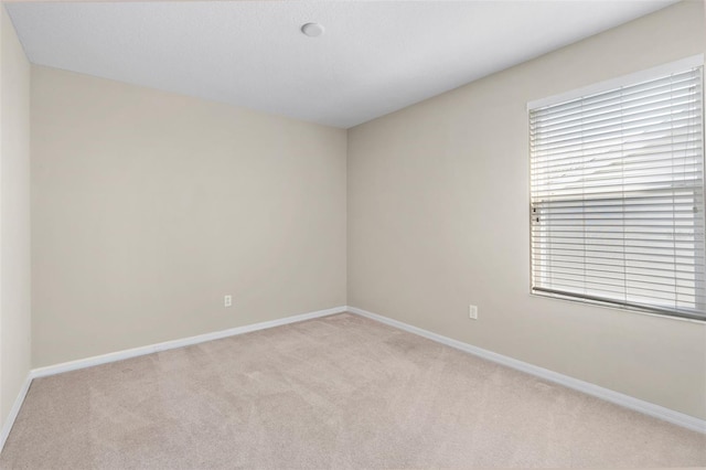 empty room featuring light carpet