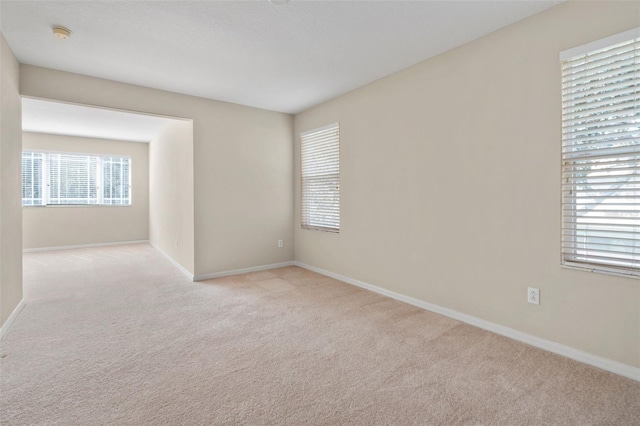 unfurnished room with light colored carpet