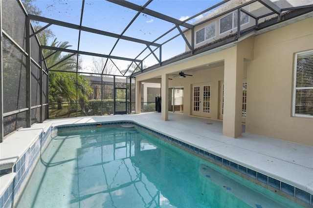 view of pool with a patio, a lanai, ceiling fan, and french doors