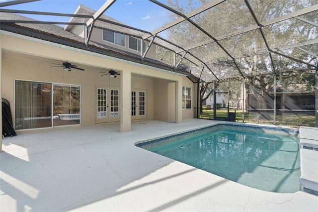 view of pool featuring a patio area, french doors, ceiling fan, and glass enclosure