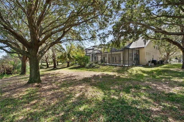 view of yard featuring glass enclosure