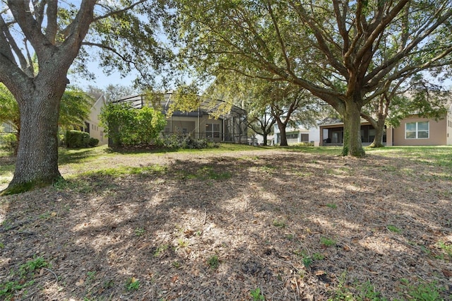 view of yard featuring a lanai