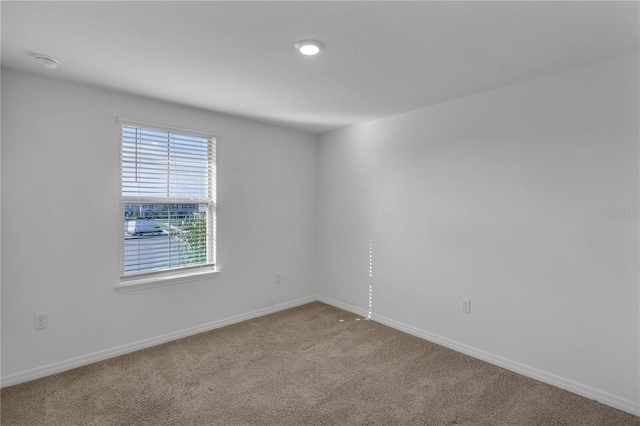 unfurnished room featuring carpet flooring