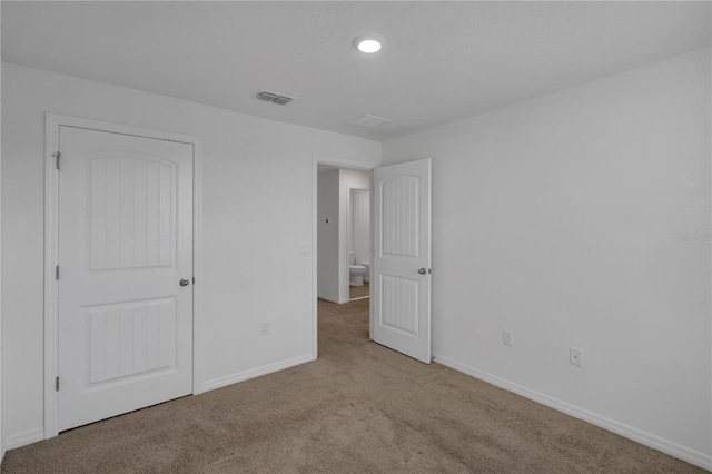 unfurnished bedroom featuring light carpet