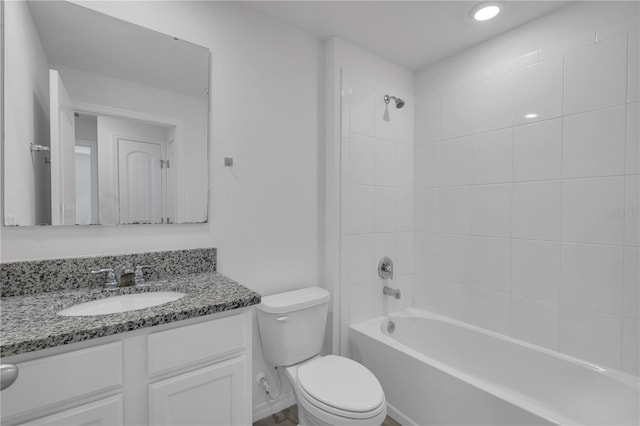 full bathroom featuring vanity, tiled shower / bath combo, and toilet