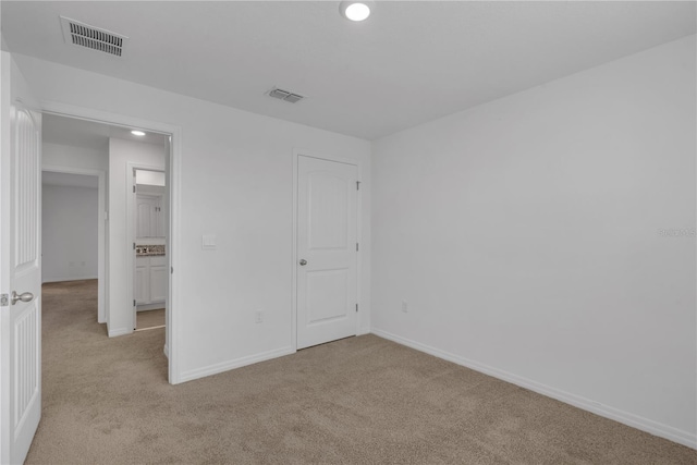 unfurnished bedroom with light carpet